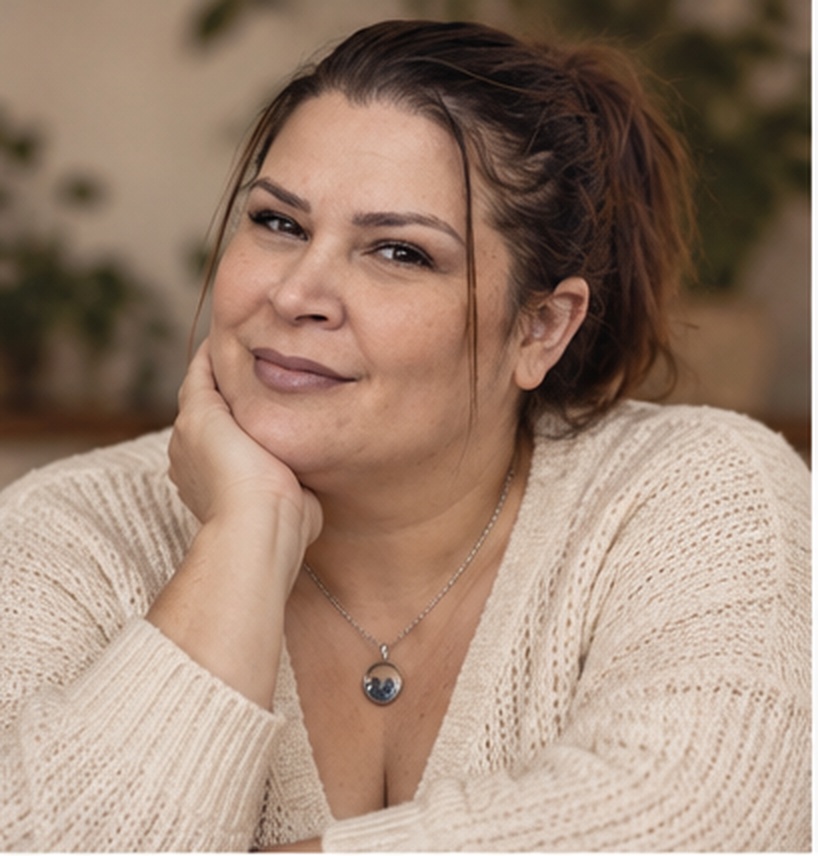 Danielle in a cream sweater, hand resting at her chin