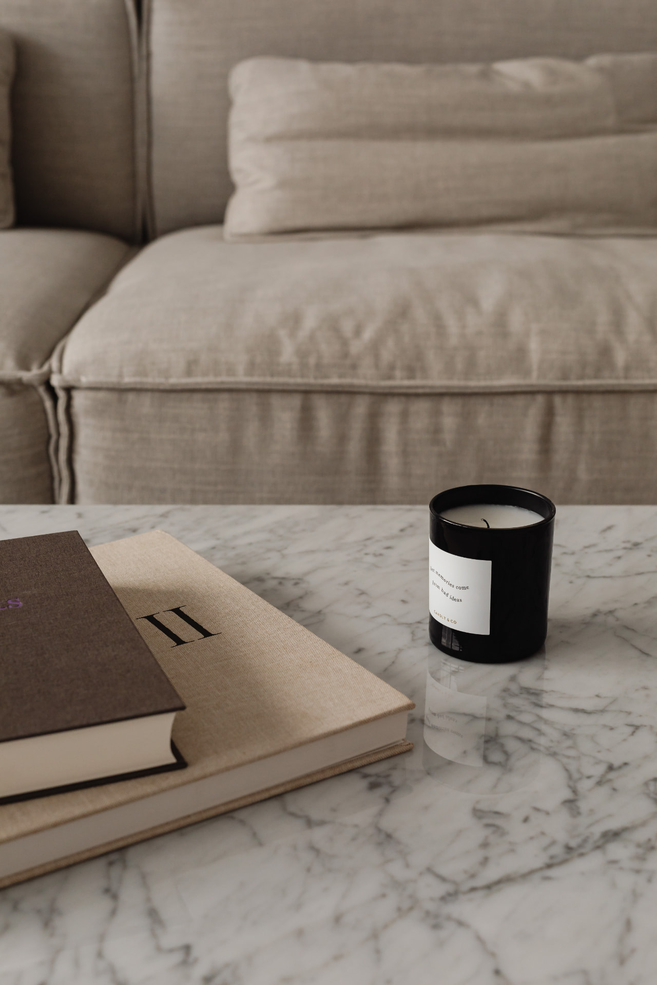 Books and a candle on a marble table